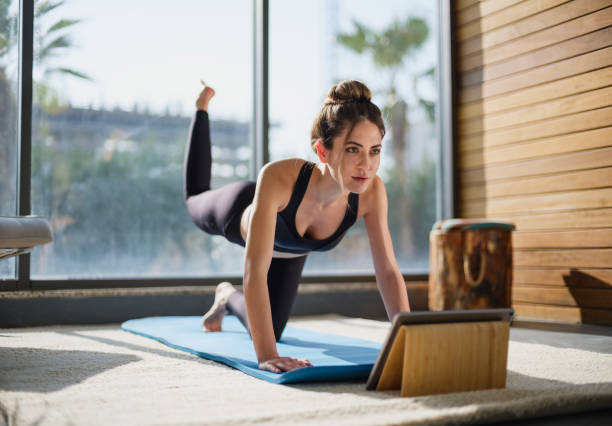 A young woman in Arlington, VA, doing a workout at home, staying active and focused on her fitness goals