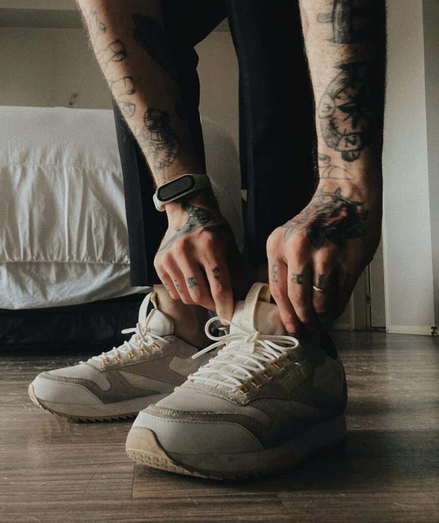 A young man using fitness trackers during his workout, monitoring his performance and staying motivated to reach his fitness goals