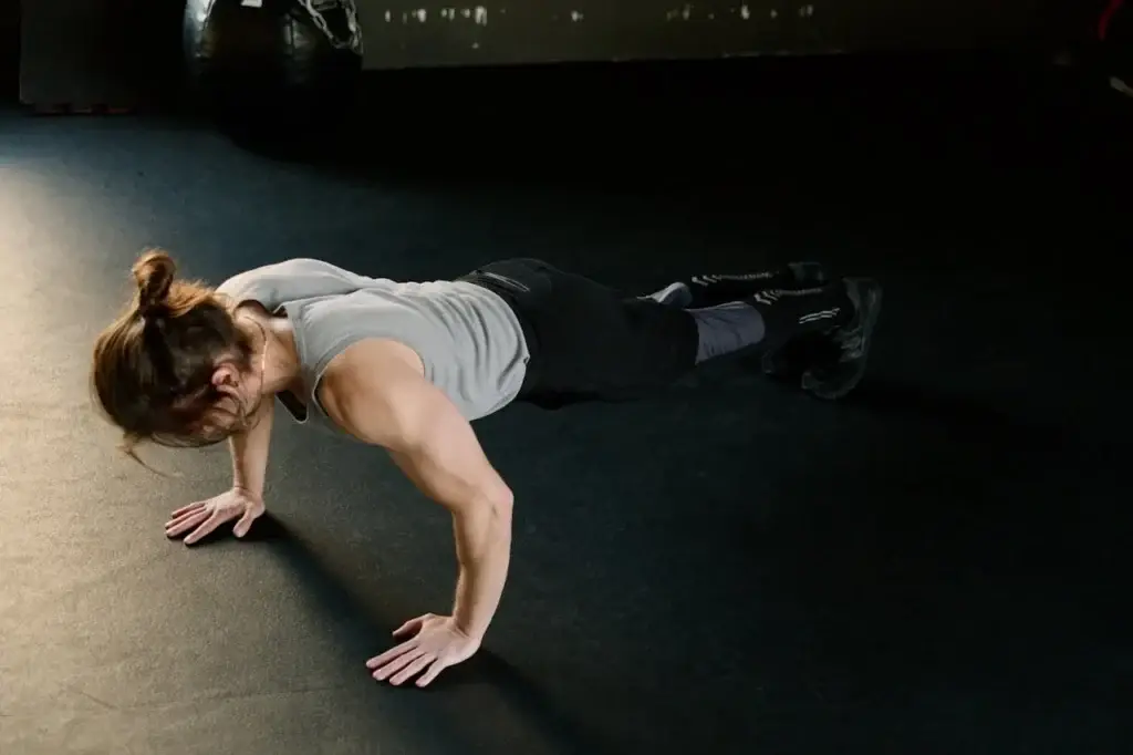 A young woman in the U.S. doing Push-ups at home - strength training without equipment