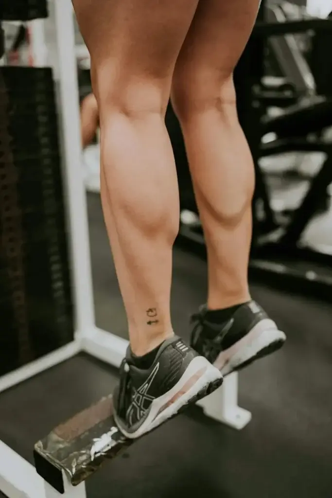 Woman doing calf raises at home - strength training without equipment for beginner women