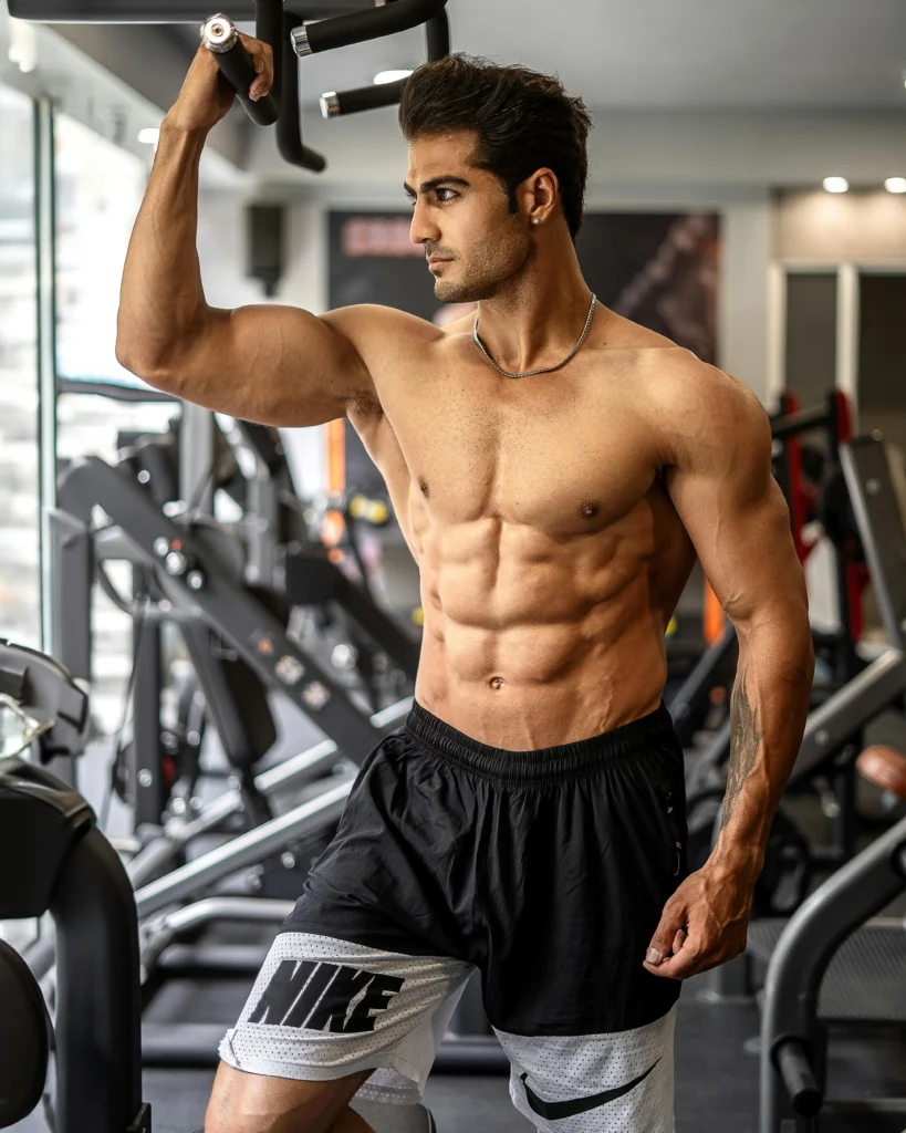 Man with a lean, muscular physique performing a dumbbell workout at the home gym, ideal for cutting workouts at home in Los Angeles