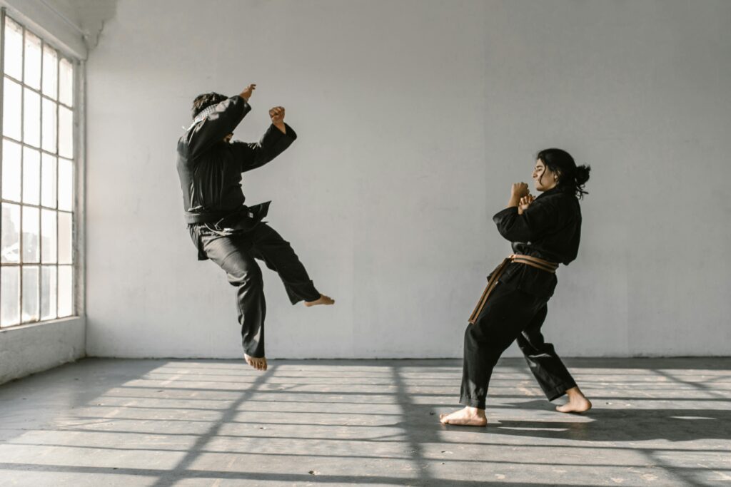 Two people engaged in practice for Mixed Martial Arts (MMA) in Las Vegas, simulating a fight scenario to improve their skills and techniques during their training.