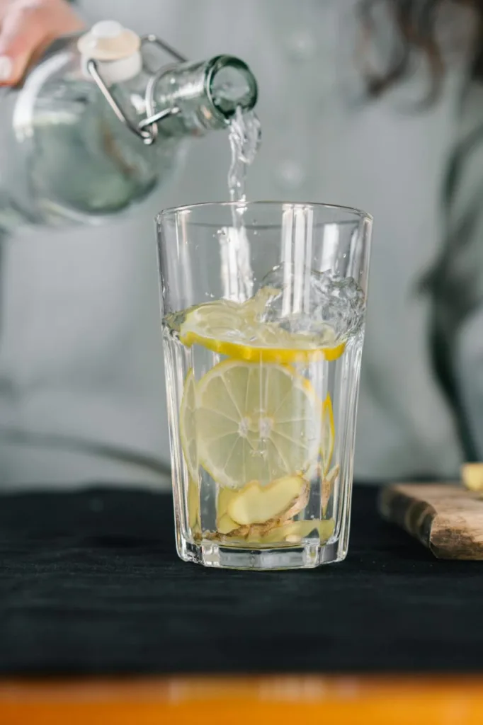 Refreshing glass of water with lemon, perfect for hydration and supporting a belly fat loss diet.