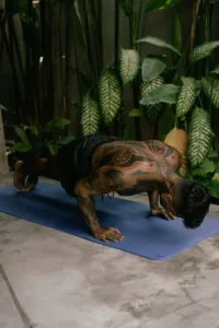 Young American man doing push-ups on a mat at home, demonstrating bodyweight workout strength